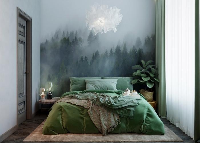 Mẫu phòng ngủ nhỏ 9m2 với tông xanh mộc mạc. Bức tường phong ngủ được vẽ sơn nước phong cảnh rừng cây tạo sự ấn tượng cho căn phòng