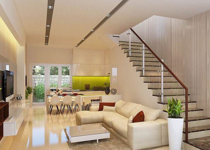 Thiết kế tone trắng với ánh đèn vàng nhẹ làm không gian phòng khách nhà ống 5m2 có cầu thang trở nên ấm cúng